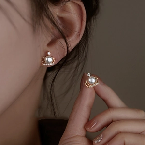 Elegant gold crown pearl earrings with zircon inlay shown on a model for a chic look