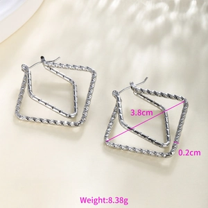 Detail view of silver chain-textured square hoop earrings with 3.8cm measurement