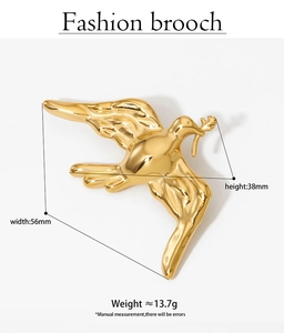 Detailed view of a gold peace dove brooch with dimensions of 56mm x 38mm on white background