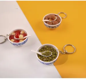 Detail view of miniature PVC blue and white porcelain bowl pendants with fake food models