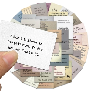 Detail of vintage typewriter style inspirational quote stickers on textured paper