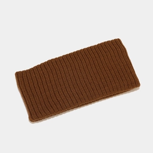 Close-up of deep brown ribbed knit headband texture and elastic wool material