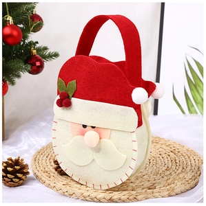 Detailed view of red felt Christmas gift bag featuring a cartoon Santa Claus design