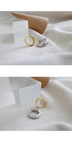 Macro shot of S925 sterling silver hoop earrings with polished gold and silver finishes