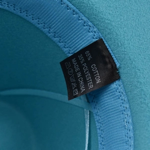 Detailed macro view of the inner sweatband and cotton polyester fabric care label