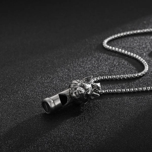Vue macro détaillée d'un pendentif sifflet tête de loup en acier titane mat vintage