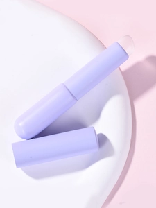 Macro detail of portable silicone lip brushes with covers on a white stone tray