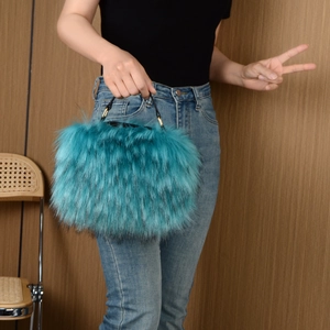 Detail showing high-quality teal faux raccoon fur texture of the plush crossbody handbag