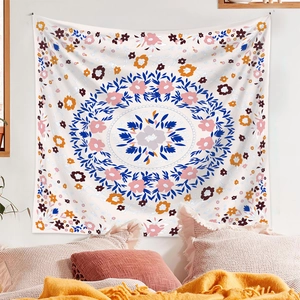 Detail of floral mandala tapestry hanging above a bed for a cozy room decor ambiance