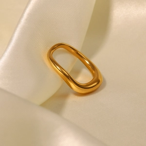 Bague irrégulière en acier inoxydable plaqué or 18 carats sur fond de soie crème élégant