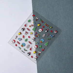 Detail of 3D embossed Christmas nail stickers featuring Santa and festive gift patterns