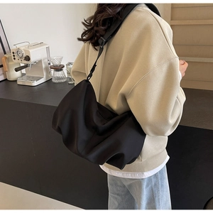 Detail of black large capacity nylon crossbody tote bag with adjustable shoulder strap