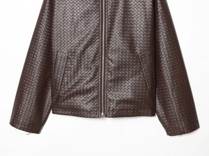 Close-up of dark brown woven texture with silver metal zipper on men's jacket