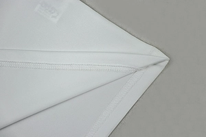 Close-up of white halter dress fabric showing premium double-needle stitching and seams