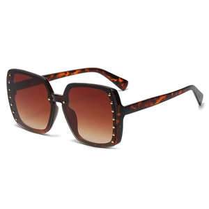 Oversized square tortoiseshell sunglasses with gold rivets and brown gradient lenses