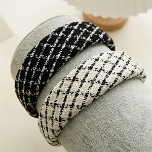 Detail of tweed hairbands in black and white houndstooth patterns on display