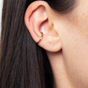 Close-up of minimalist gold S925 sterling silver ear cuff shown on model's ear