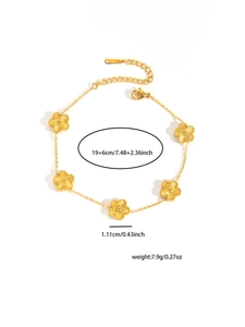 Macro shot of gold flower bracelet showing detailed petal texture and lobster clasp size
