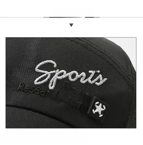 Close-up of black mesh baseball cap with white Sports and star embroidery detail