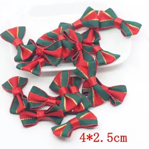 Detailed view of red and green striped Christmas bows with gold trim, size 4x2.5cm