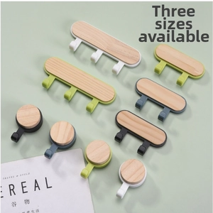 Close-up of minimalist wood wall hooks in Morandi colors and three sizes