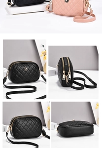 Close-up of quilted camera bag featuring dual zippers, gold floral logo and leather strap