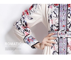 Detail view of floral print dress showing elastic cuffs and matching waist belt buckle