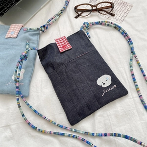 Detail of mini denim crossbody bags with cute animal embroidery and plaid flap accents