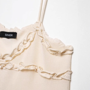 Chic beige knitted camisole top featuring elegant tiered ruffle trim and slim straps
