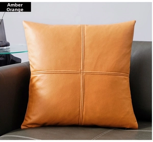 Close-up of amber orange technical fabric pillowcase with cross-stitched center detail