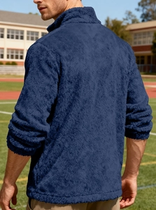 Detail of navy blue fleece jacket fabric and high collar zip-up texture for men