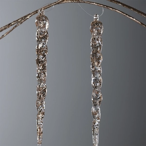 Christmas clear acrylic icicle ornaments with gold sequins hanging on a golden branch