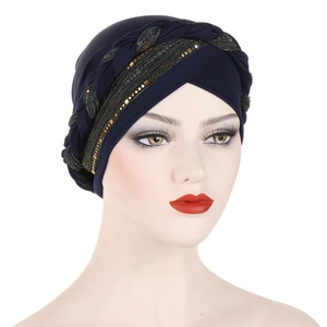 Close-up of navy blue turban hat featuring sequin accents and braided ethnic details