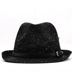 Detail of sequin fedora hat showing the black leather band and golden metal buckle