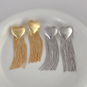 Elegant gold and silver heart tassel drop earrings with brushed metal finish