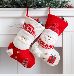 Detail of knitted Christmas stockings featuring 3D Santa and Snowman characters
