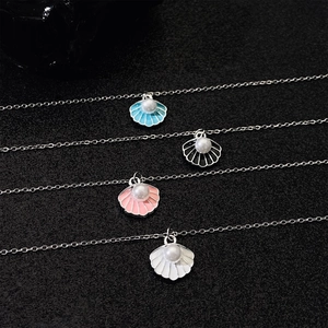 Elegant silver shell pendant necklaces with pearl accents in blue black pink and white
