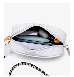 Top view of white crossbody bag with wide letter print strap showing interior capacity