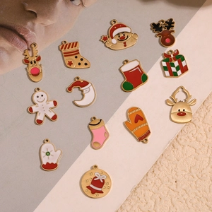 Detailed view of 14K gold plated Christmas charms featuring colorful enamel holiday shapes
