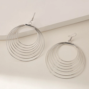 Detailed view of layered silver concentric circles earrings with polished mirror finish