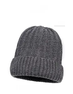 Detail view of dark gray rib-knit beanie with a brown square leather patch on cuff