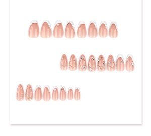 Macro detail of French style almond press-on nails with 3D gold lines and pearls