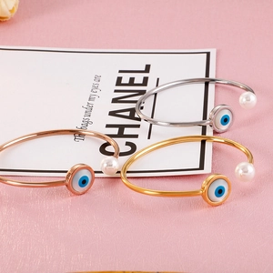 Detailed set of three Evil Eye bracelets in gold, silver, and rose gold with pearls