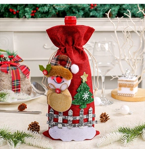 Festive detail of a red Christmas wine bottle bag with snowman and tree applique