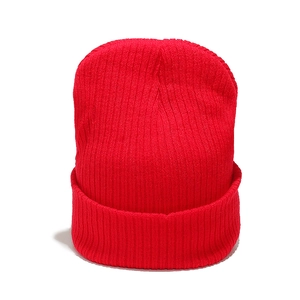 Close-up of red rib-knit beanie showing detailed texture and thick cuffed brim design