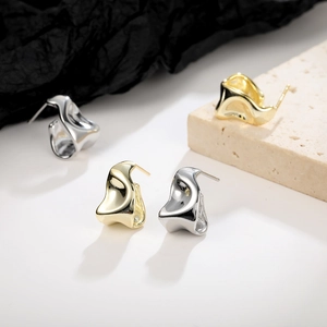 Irregular geometric earrings in gold and silver finish with liquid metal texture design