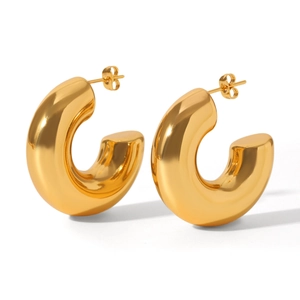 Macro detail of high-polished 18K gold plated thick hollow hoop earrings for women