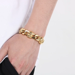 Close-up of gold skull link bracelet worn on wrist for a bold punk aesthetic look