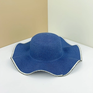 Wide brim straw sun hat in royal blue with wavy edge and black and white stitching