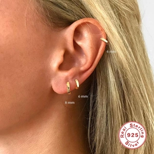 Classic 925 sterling silver gold hoop earrings in 6mm and 8mm sizes shown on ear